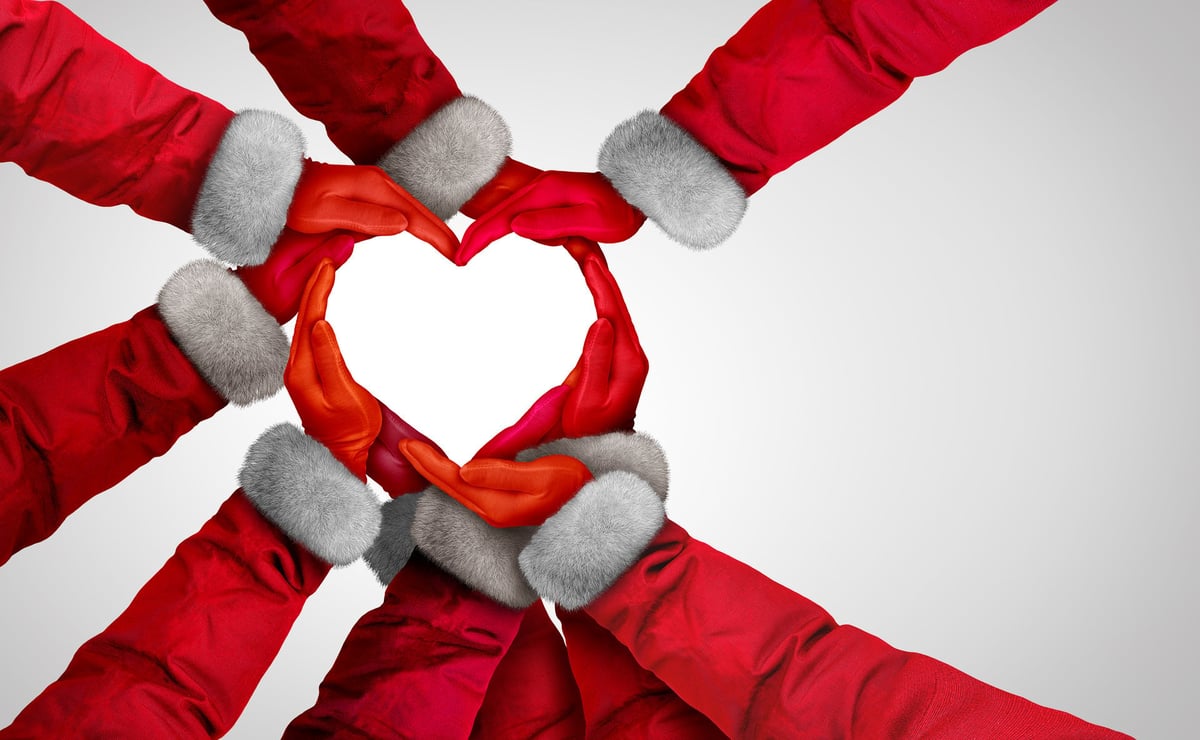 Winter Holiday Support and Christmas Holidays and community unity as a group of diverse Santa Claus hands and arms joining together for giving and celebrating hope for the New Year and the Brotherhood and compassion.